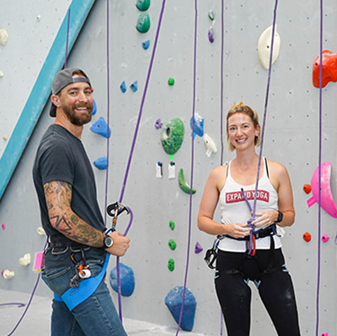 people standing in front of climbing wall