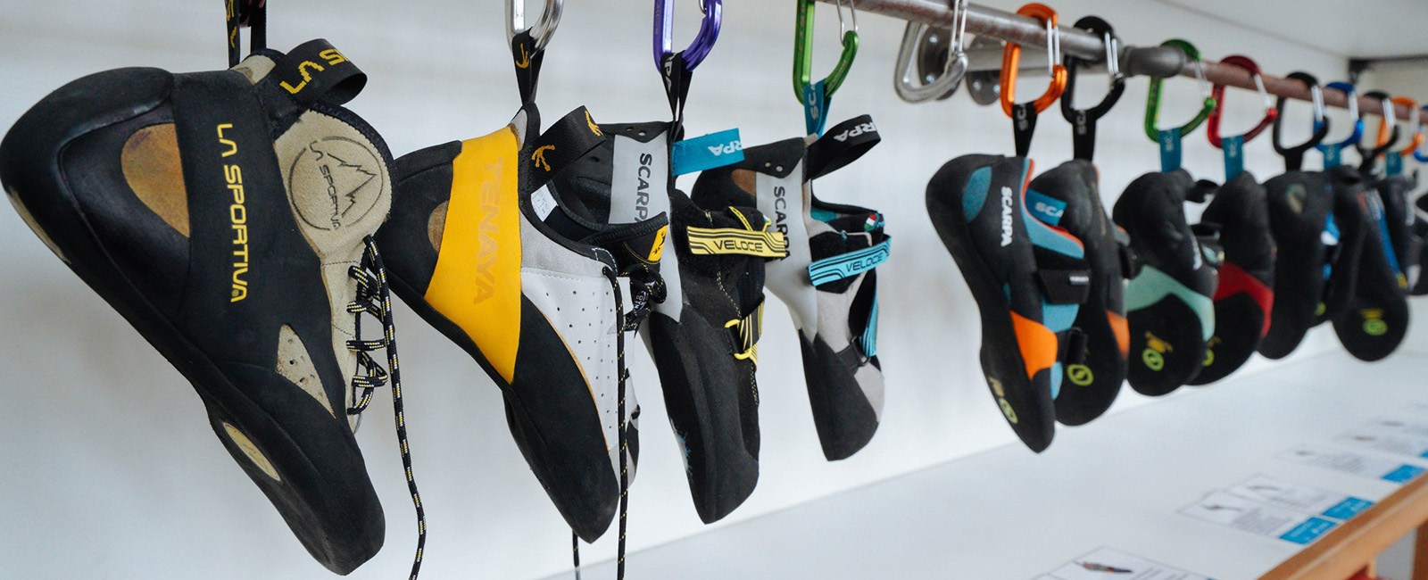 group of climbing shoes on a rack